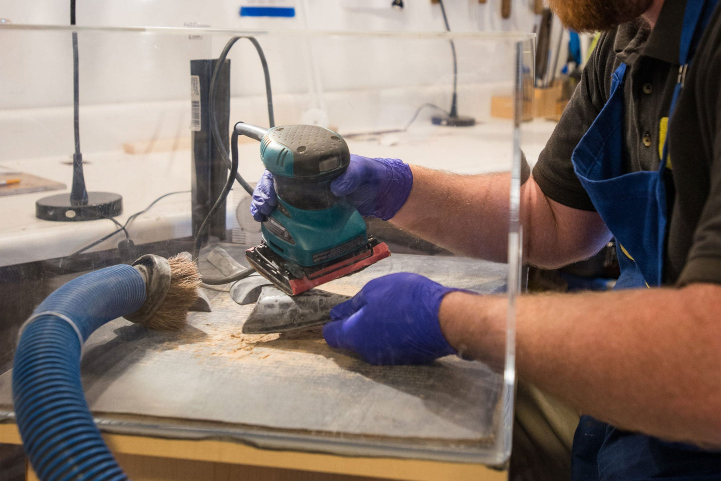 Sanding excess resin from tailpiece in the clean box